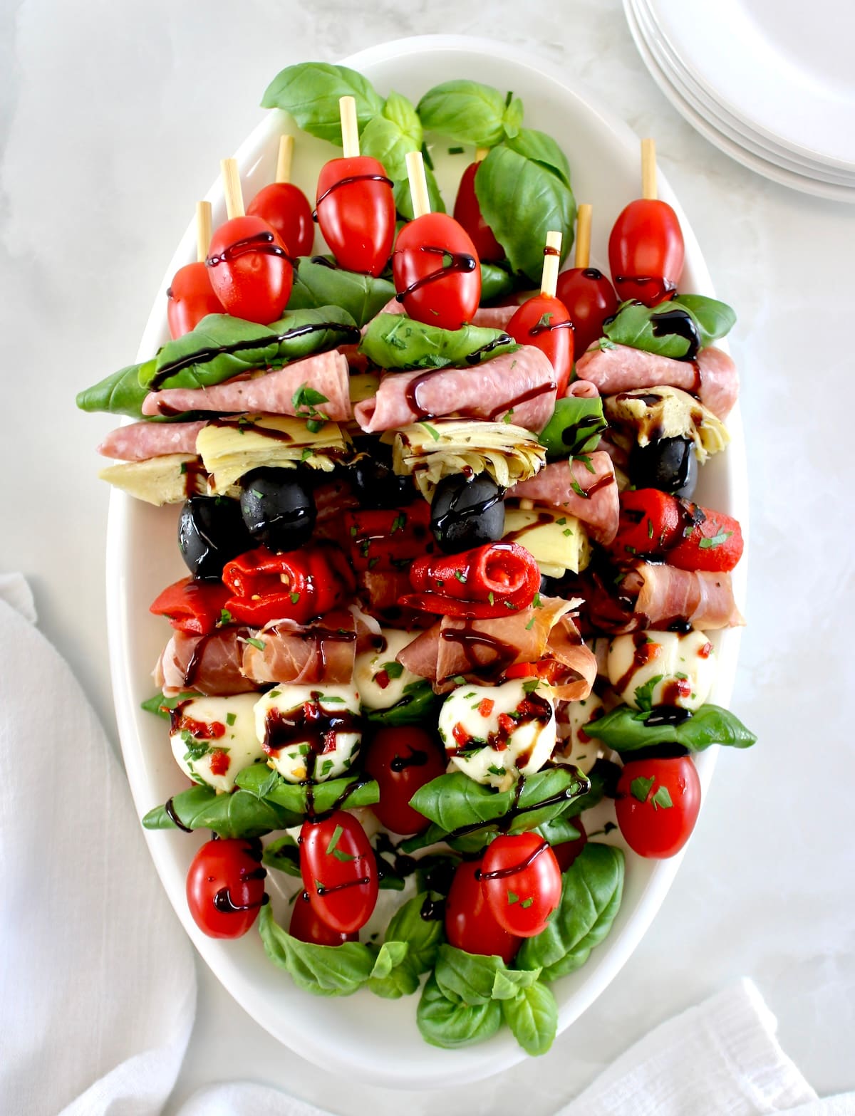 overhead view of Italian Antipasti Skewers on white platter