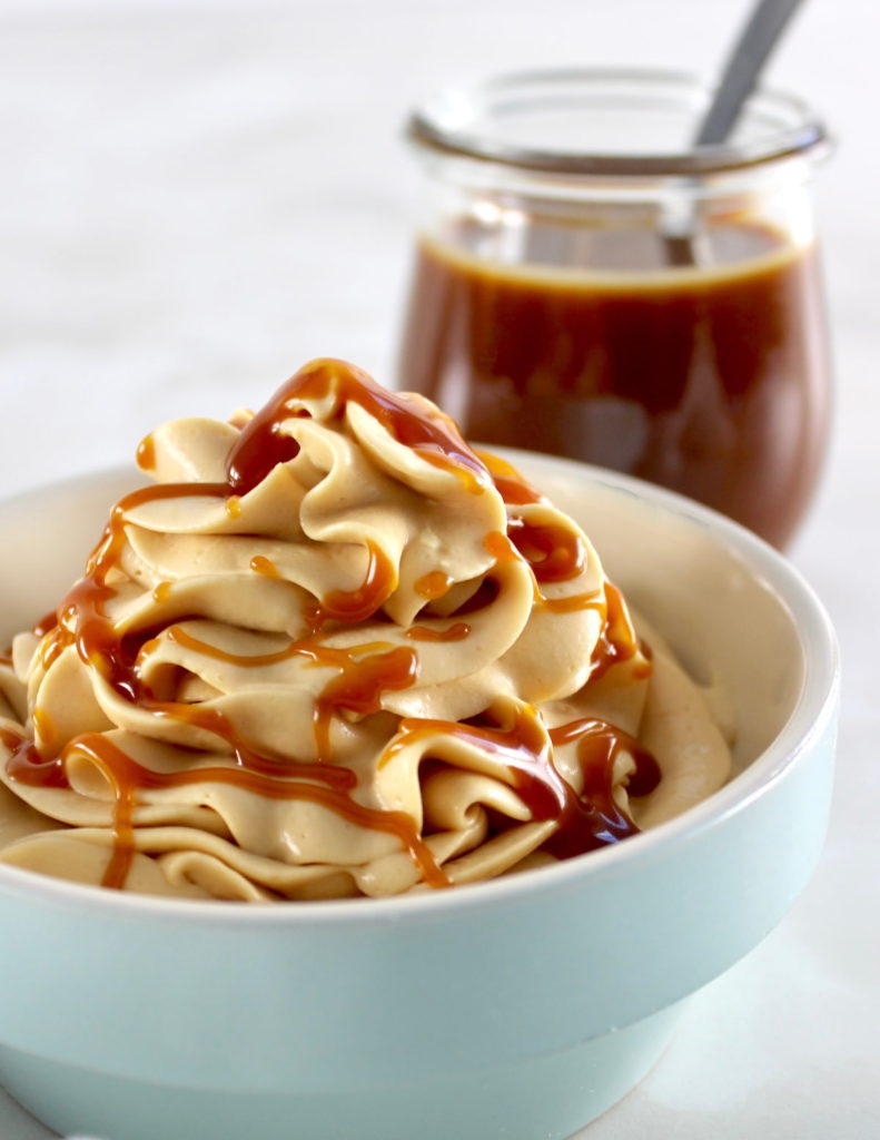 closeup of  Keto Salted Caramel Cheesecake Mousse in blue bowl with caramel in back