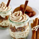 Keto Snickerdoodle Cheesecake Parfaits in open glass jars with cinnamon stick on top and on side