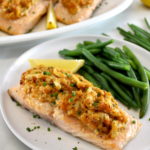 Cajun Crab Stuffed Salmon on white plate with green beans