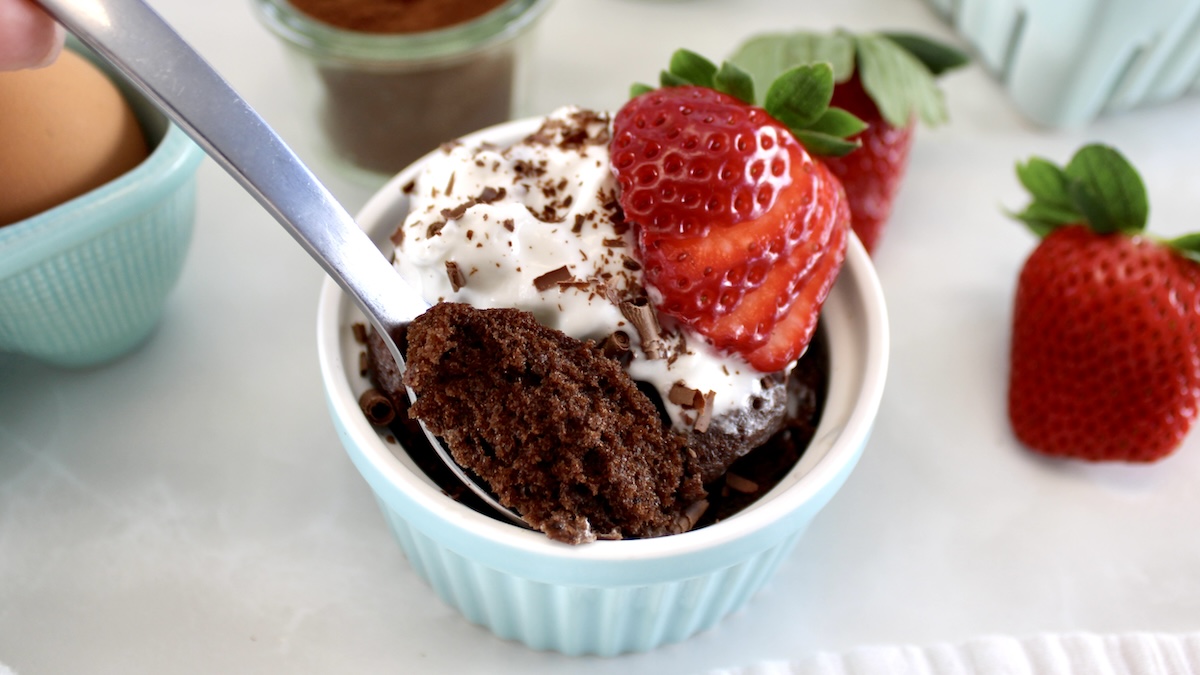 chocolate mug cake in blue ramekin with spoon