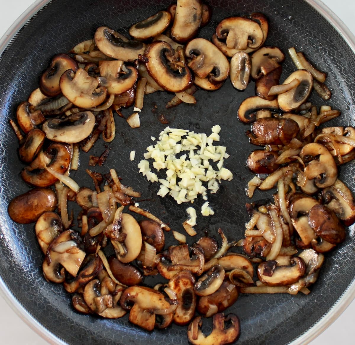 sauteed mushrooms onions and garlic in center of skillet