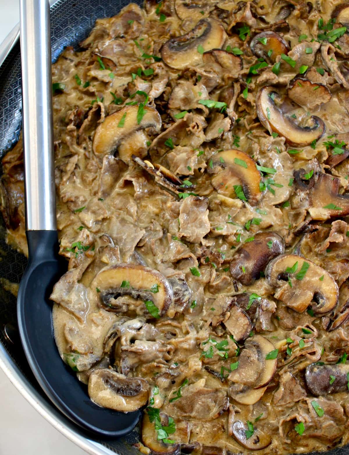 closeup of Easy Beef Stroganoff with serving spoon on side