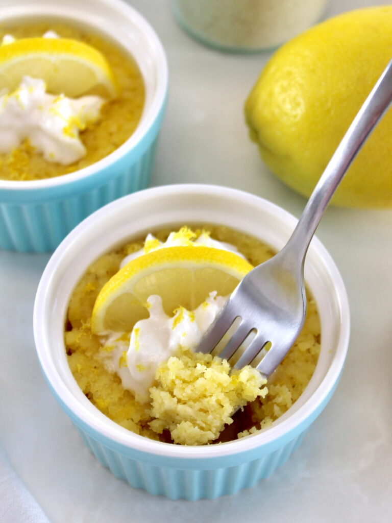 Keto Lemon Mug Cake in blue ramekin with fork