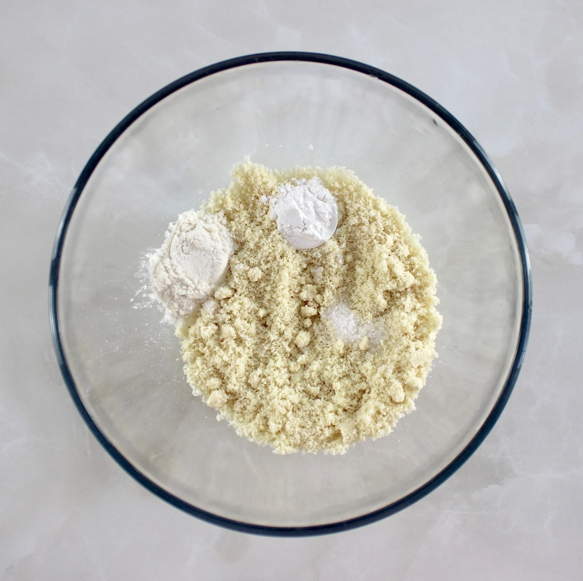 dry ingredients for Keto Lemon Mug Cake in glass bowl unmixed