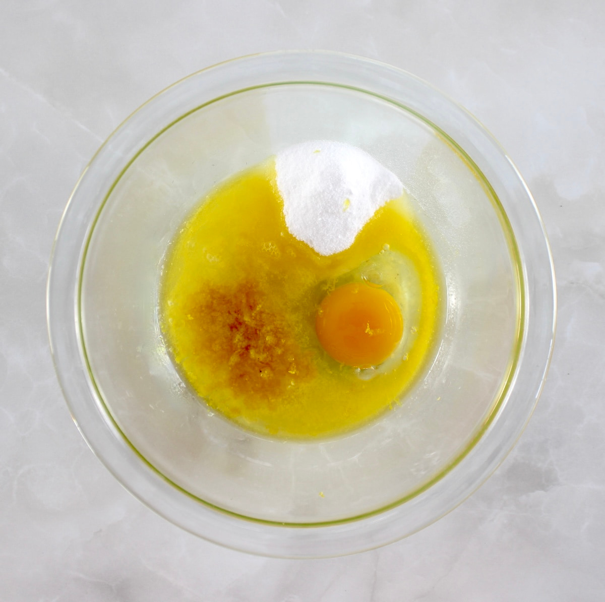 Keto Lemon Mug Cake wet ingredients in glass bowl unmixed