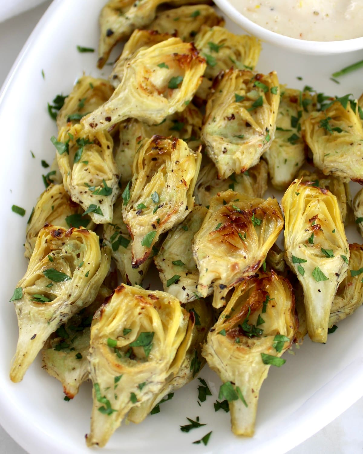closeup of Air Fryer Artichoke Hearts on white plate
