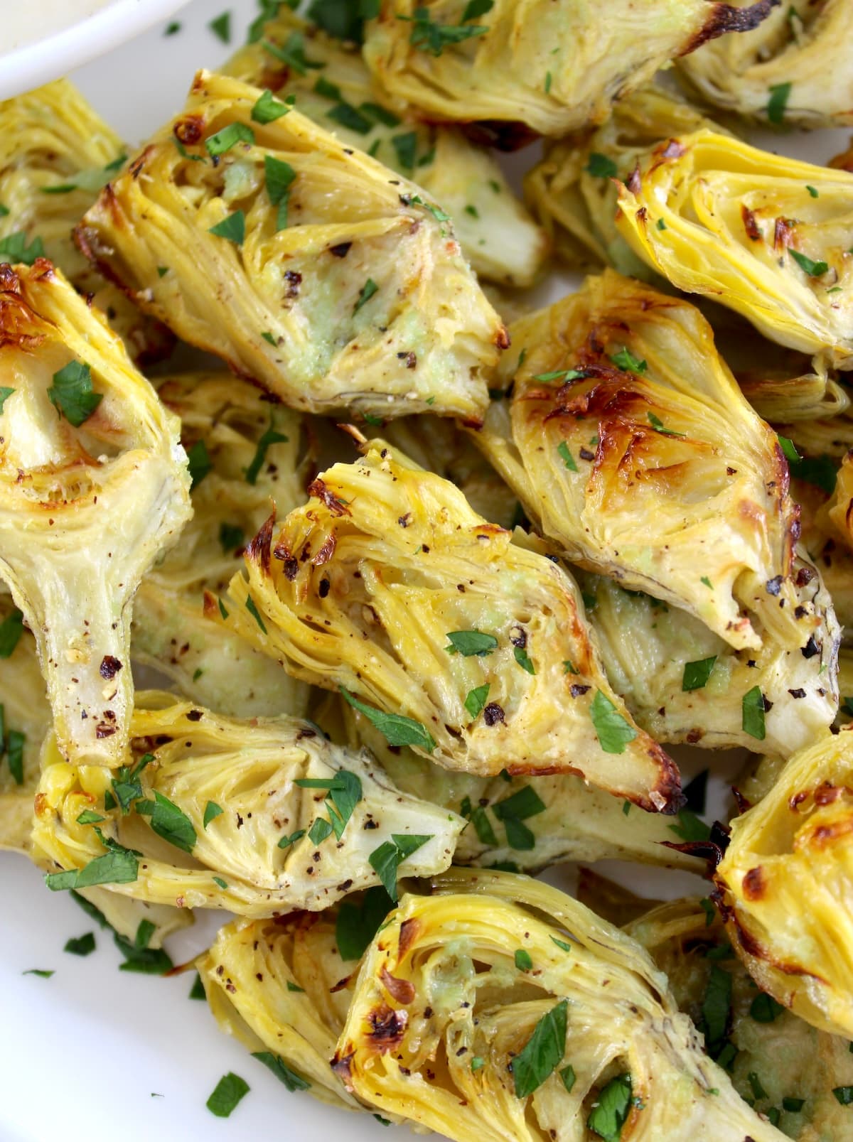 closeup of Air Fryer Artichoke Hearts on white plate