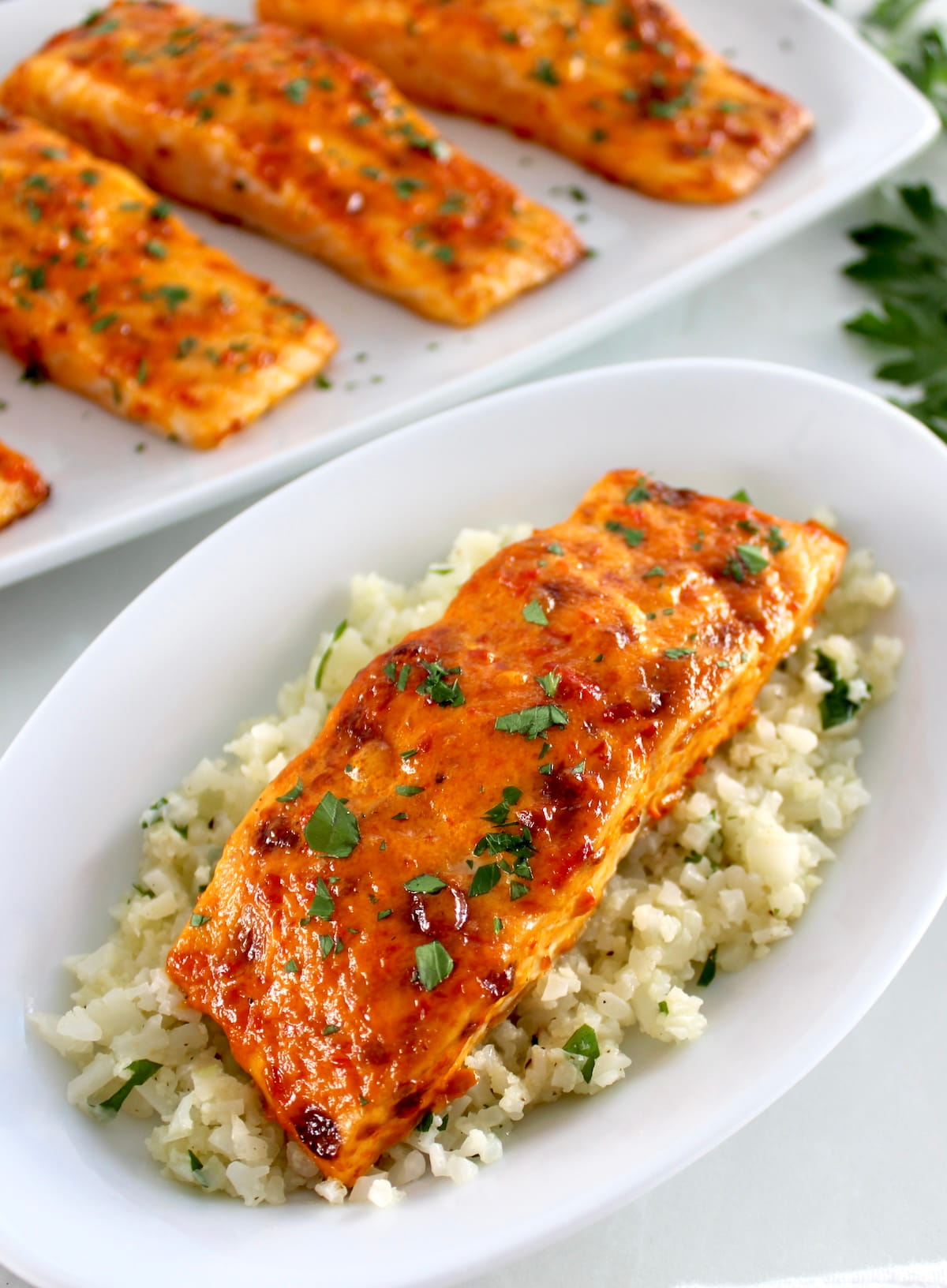 Bang Bang Salmon over cauliflower rice with more salmon in back