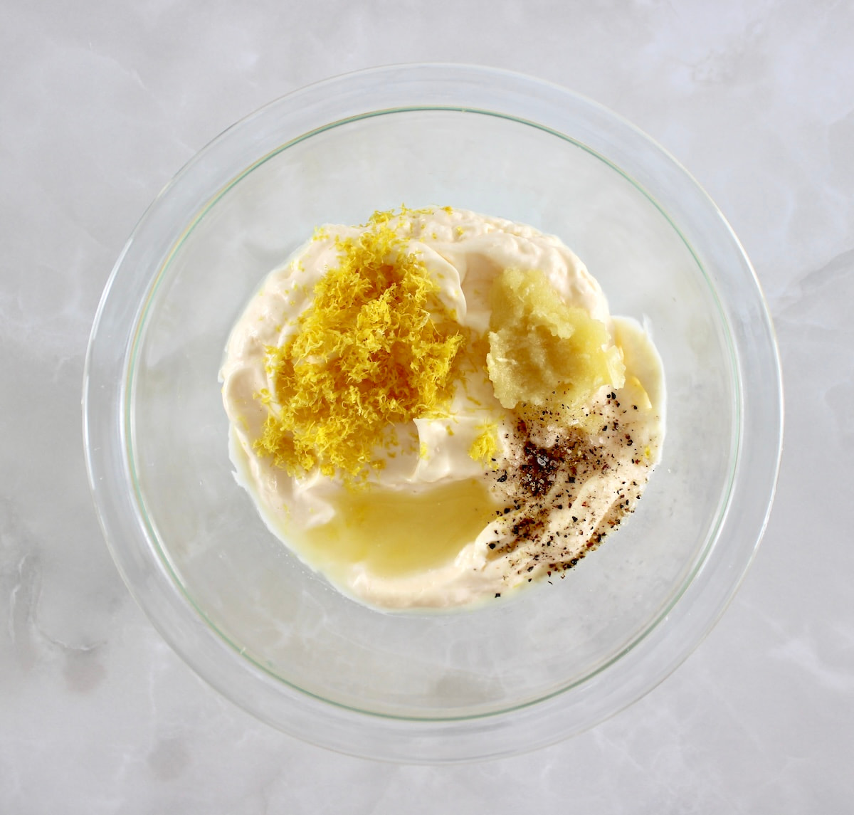 Easy Garlic Aioli ingredients in glass bowl unmixed