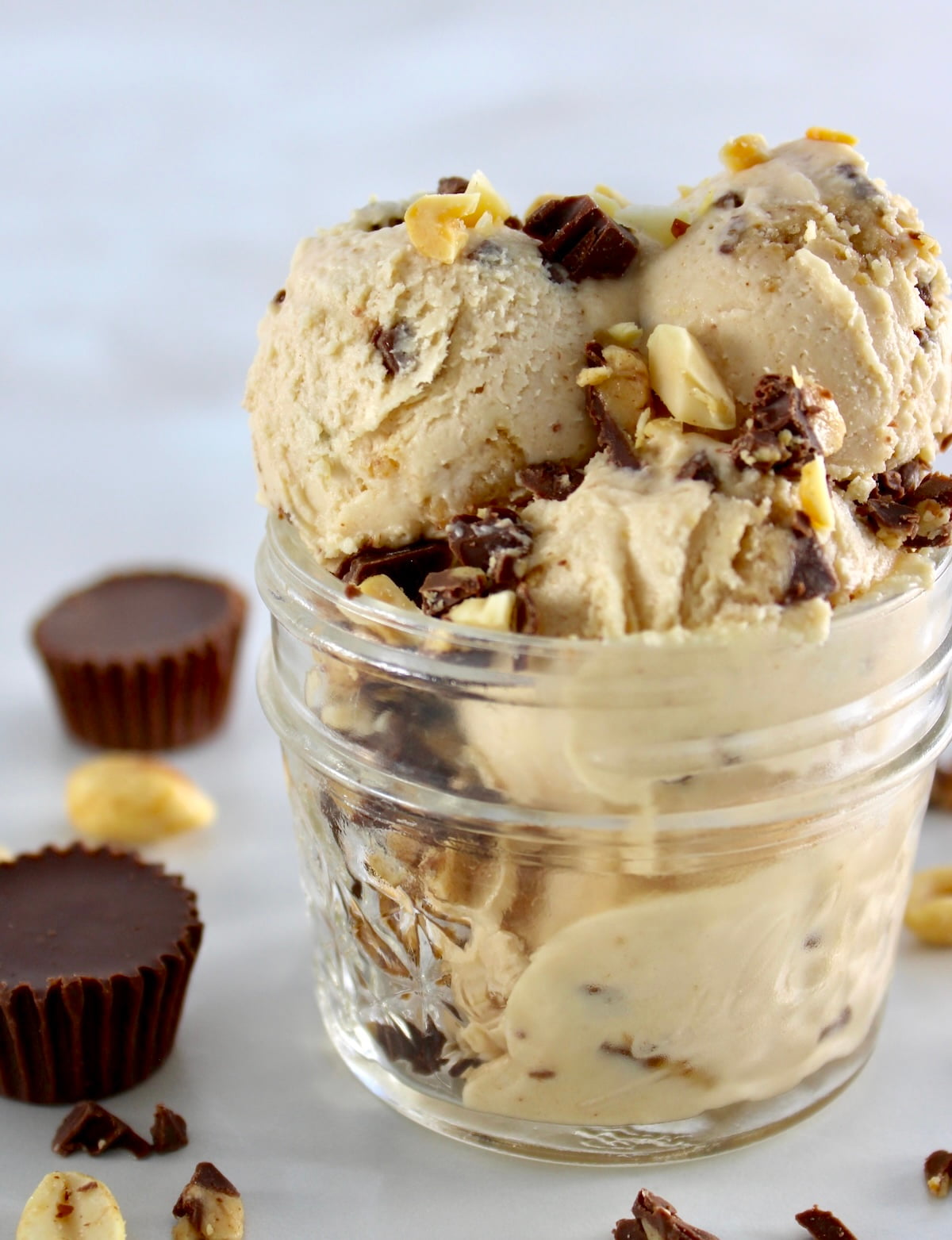 closeup of Peanut Butter Cup Mason Jar Ice Cream with chopped peanuts and chocolate
