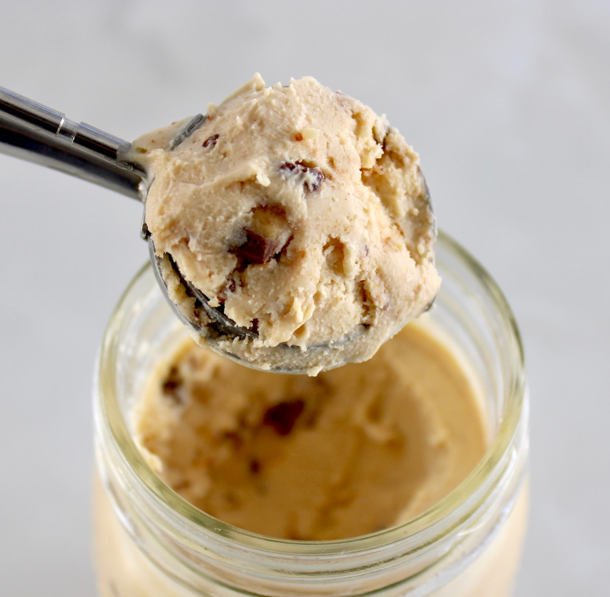 Peanut Butter Cup Mason Jar Ice Cream in ice cream scoop held up over open jar