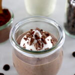 Ricotta Chocolate Mousse in open glass with whip cream and shaved chocolate on top