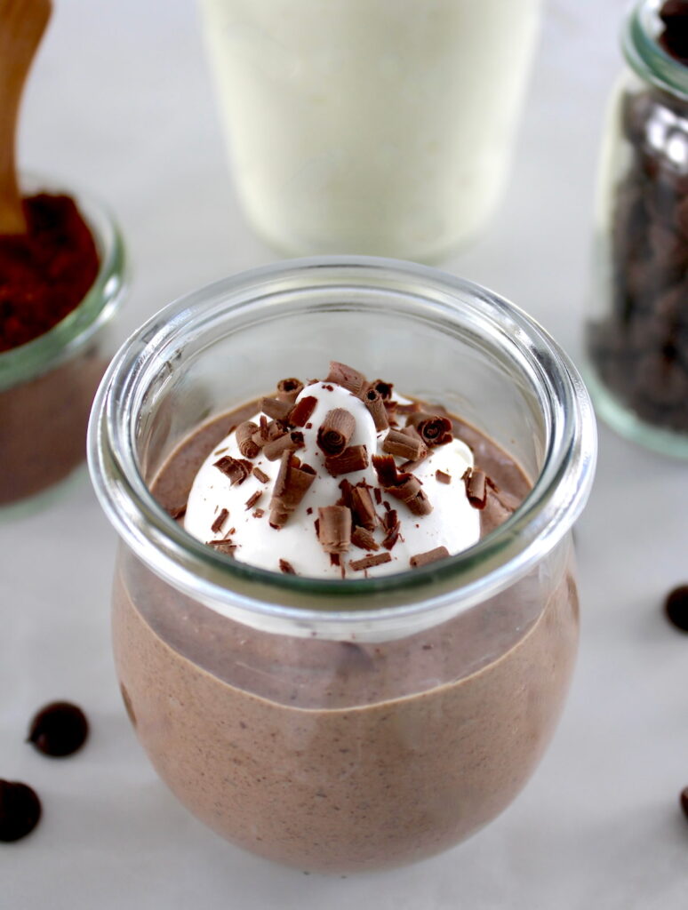 Ricotta Chocolate Mousse in open glass with whip cream and shaved chocolate on top
