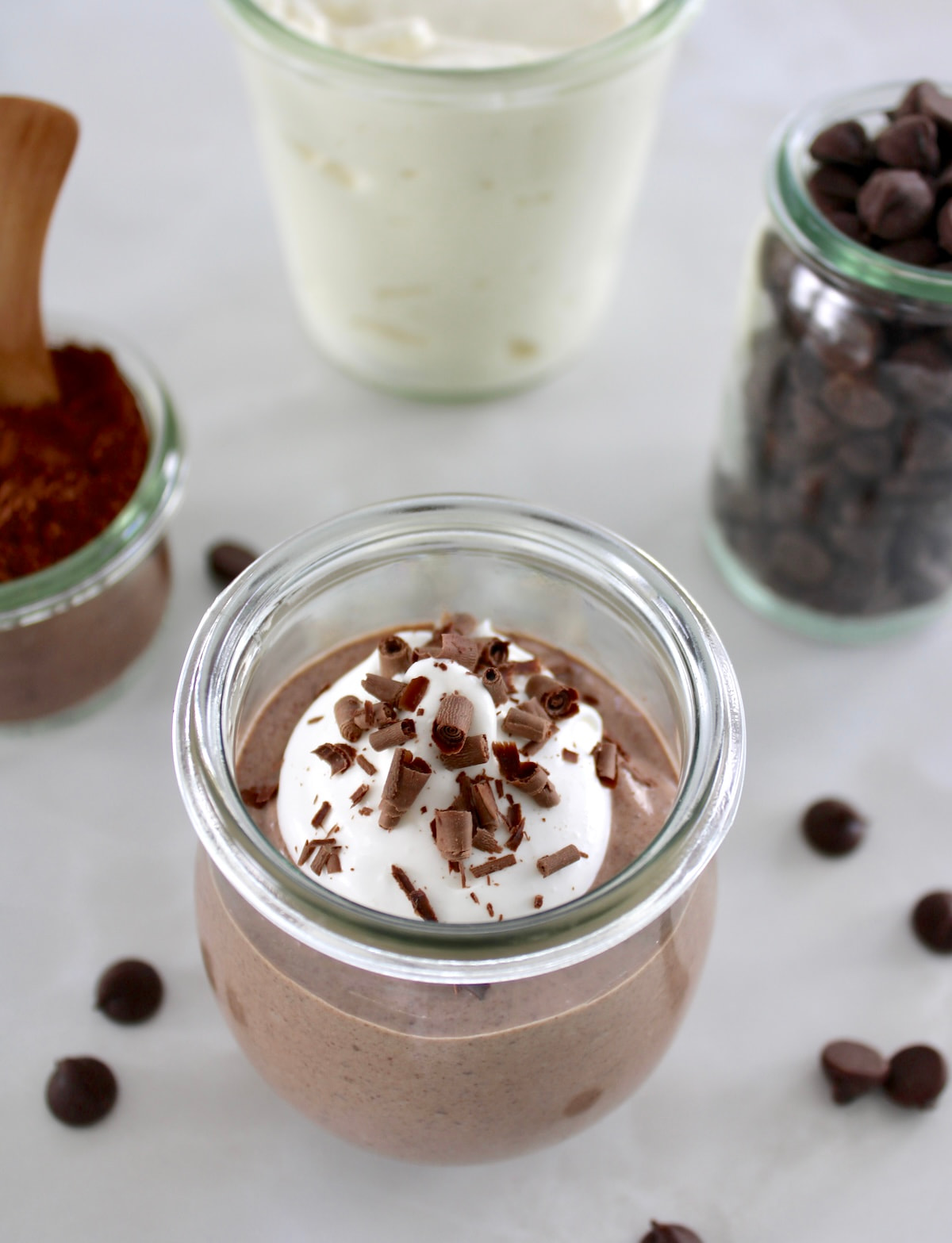 Ricotta Chocolate Mousse in open glass jar with whip cream and shaved chocolate