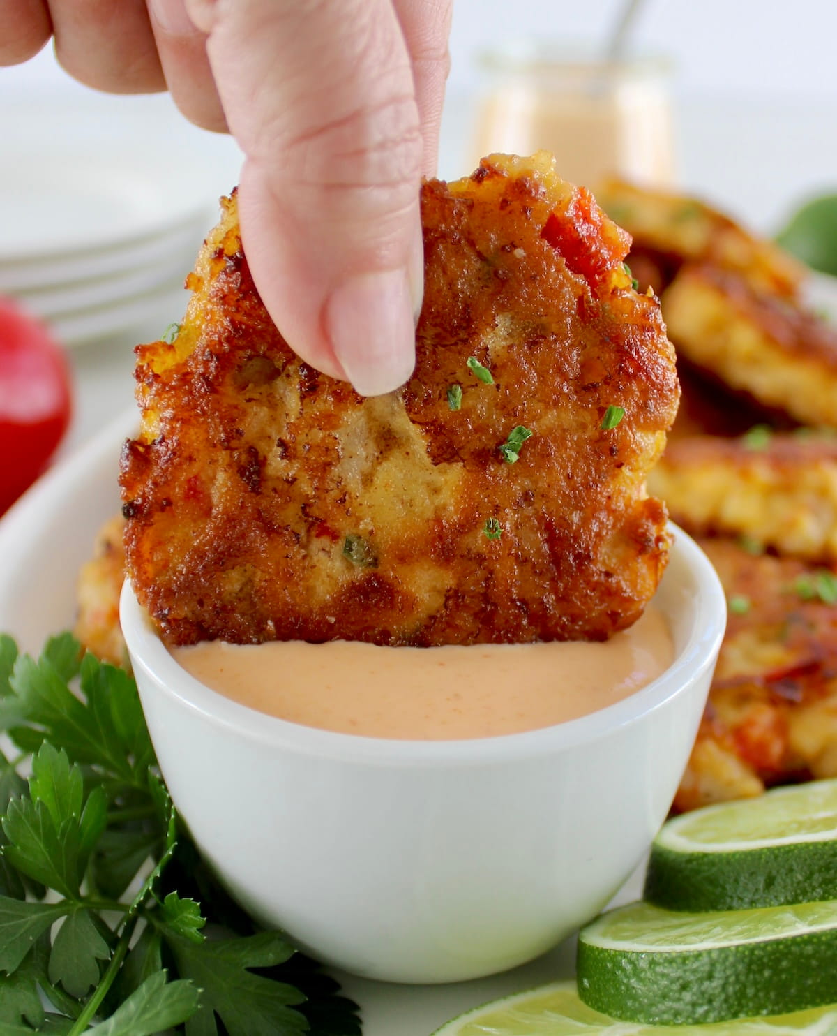 dipping Shrimp Cake into Spicy Mayo in white cup