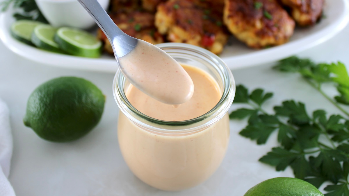 Spicy Mayo in open glass jar with spoon