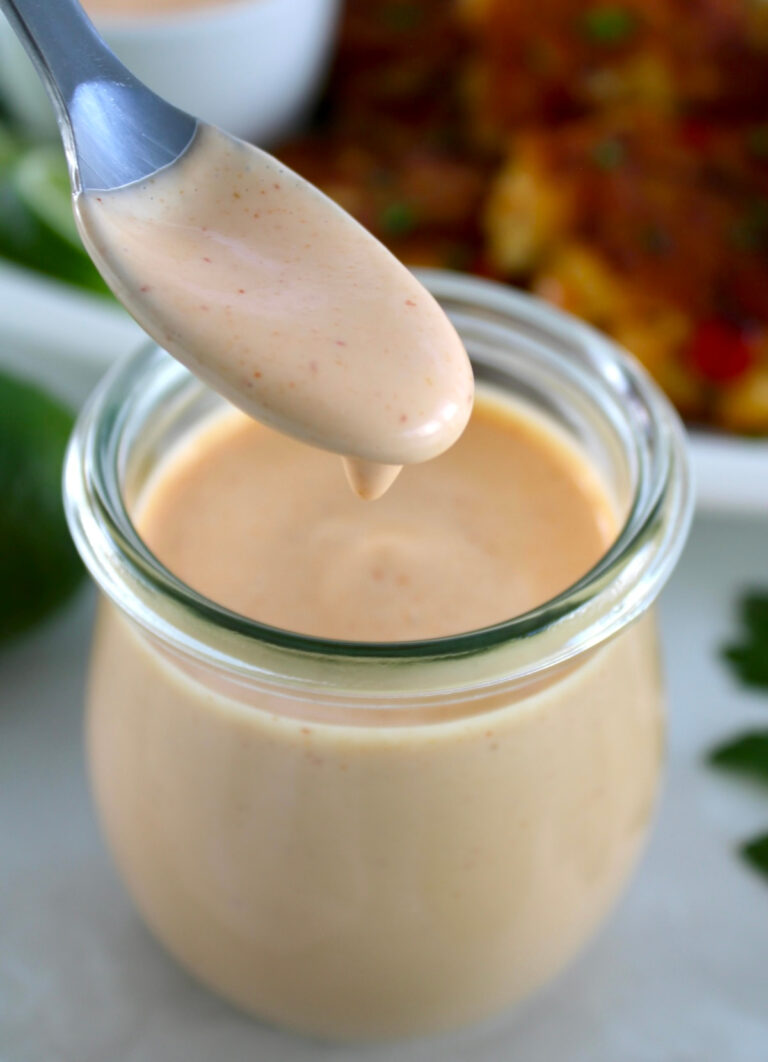 Spicy Mayo dripping off spoon in an open jar