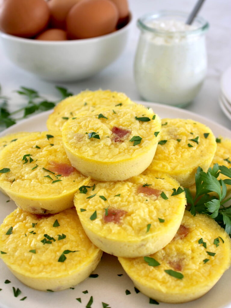 Cottage Cheese and Ham Egg Bites on white plate with chopped parsley garnish