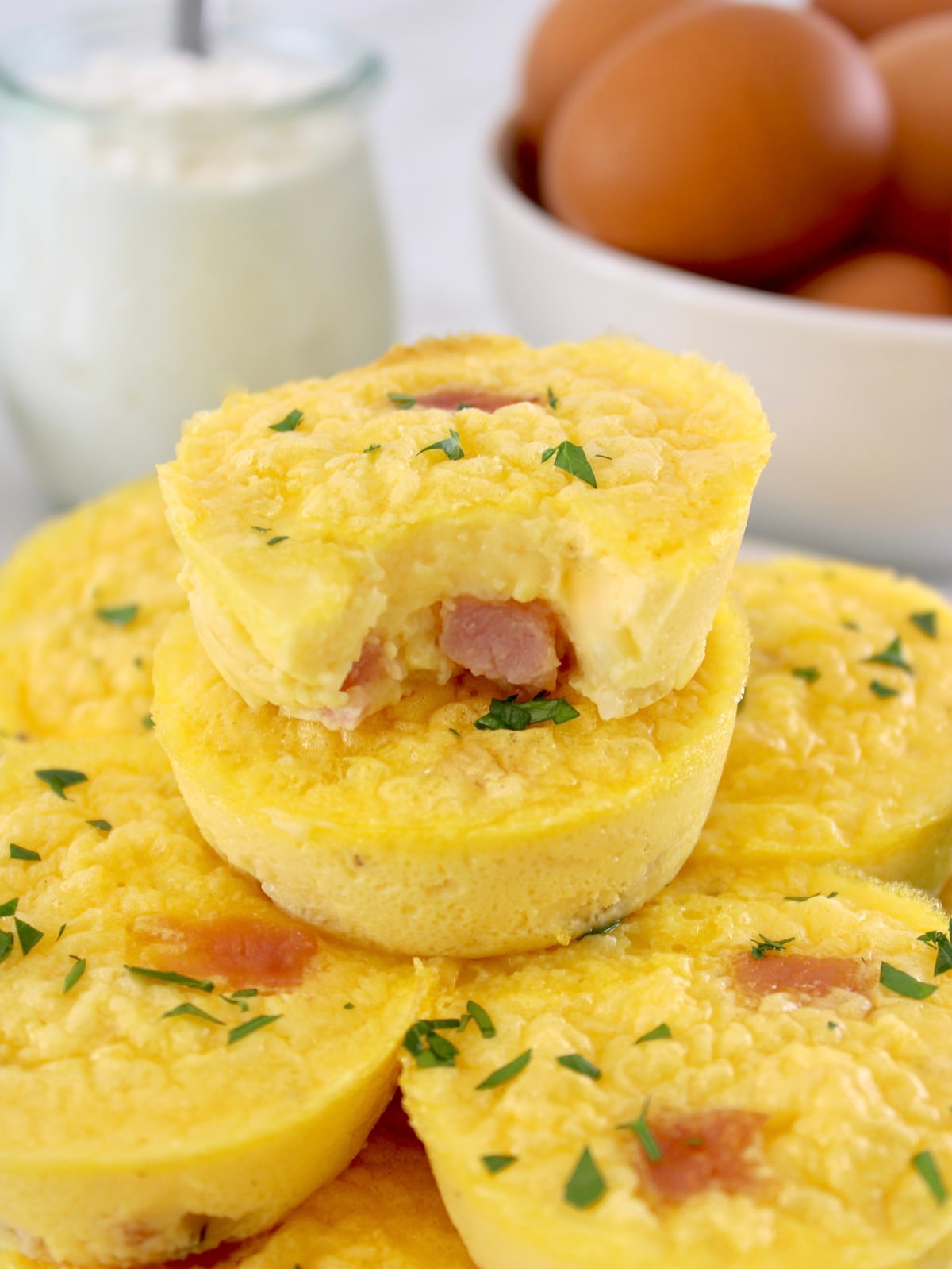 Cottage Cheese and Ham Egg Bites stacked up with bite missing from top one