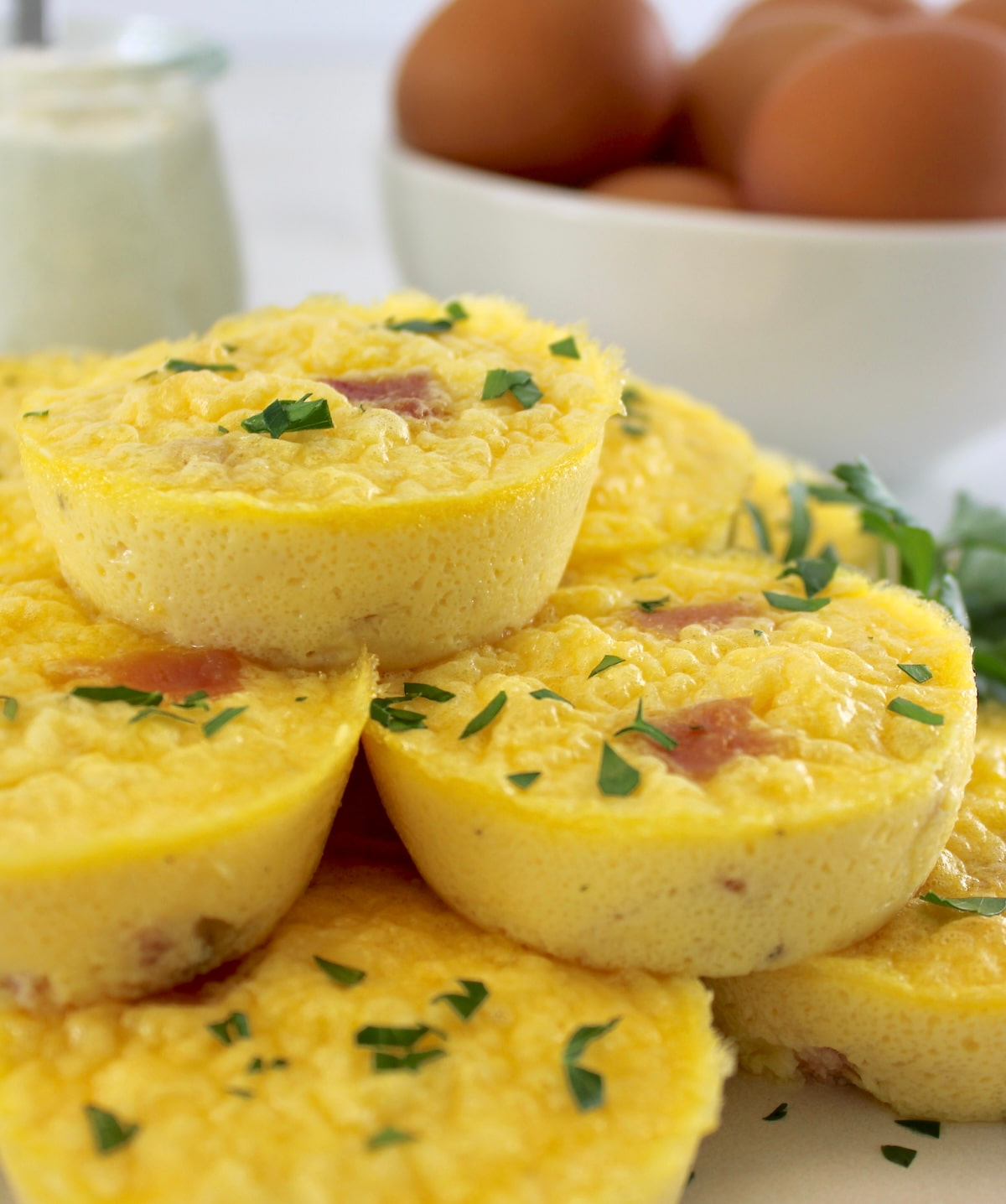 closeup side view of Cottage Cheese and Ham Egg Bites on white plate