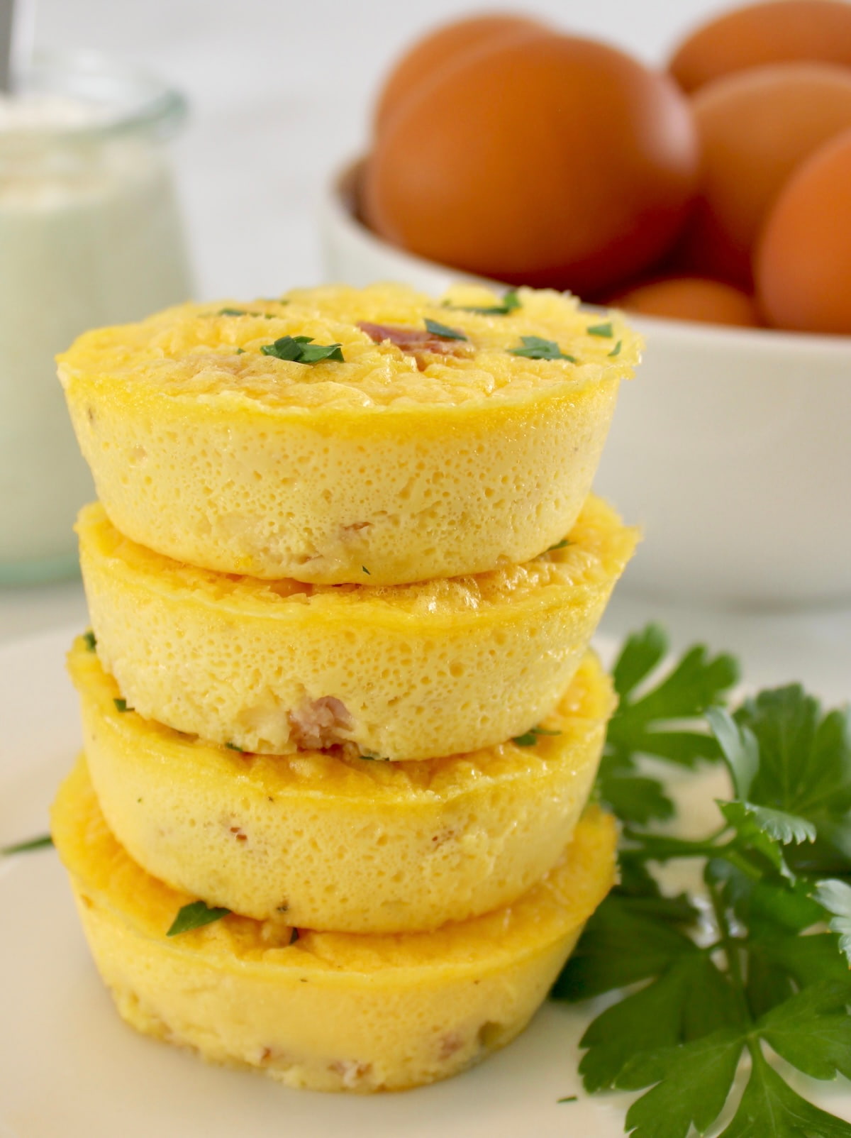 Cottage Cheese and Ham Egg Bites stacked up on white plate