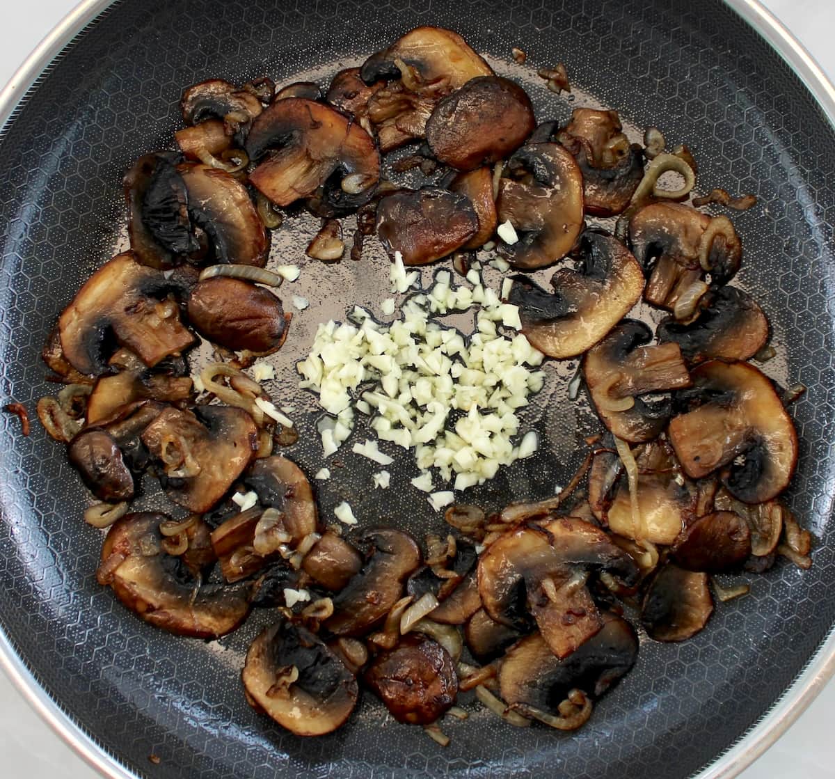 sautéed mushrooms and minced garlic in skillet
