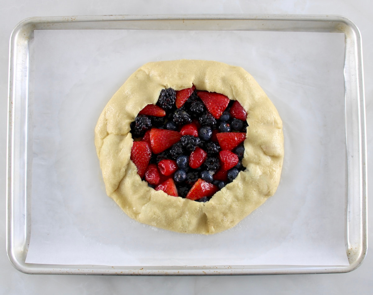 Keto Mixed Berry Galette unbaked on parchment lined baking sheet