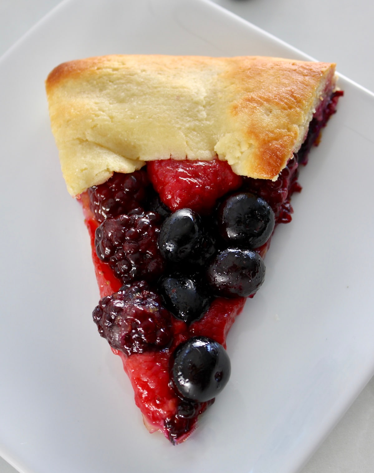 overhead closeup of Keto Mixed Berry Galette on white dish