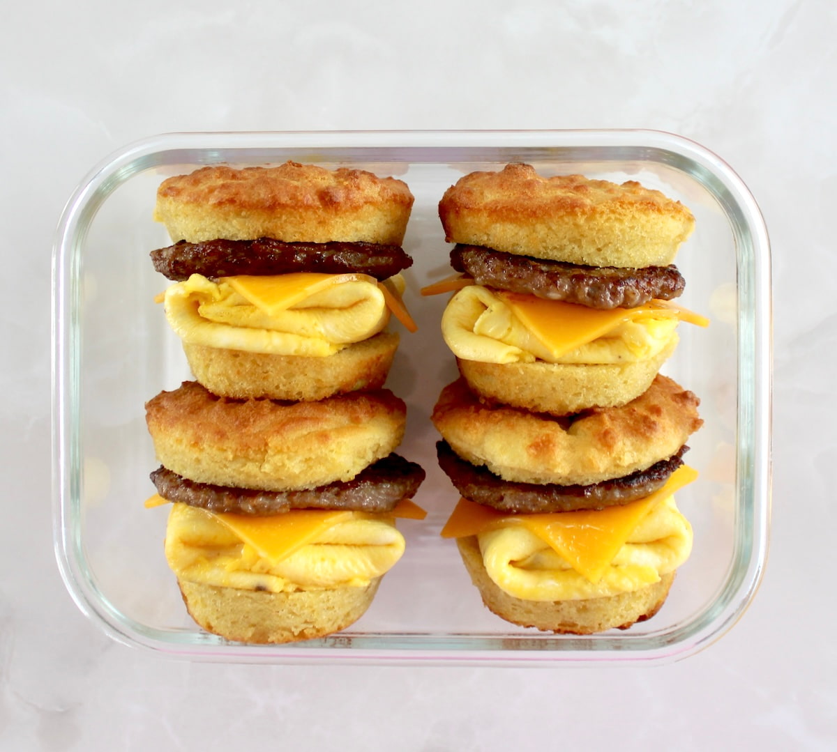 4 Keto Sausage Egg and Cheese Biscuits in glass storage container