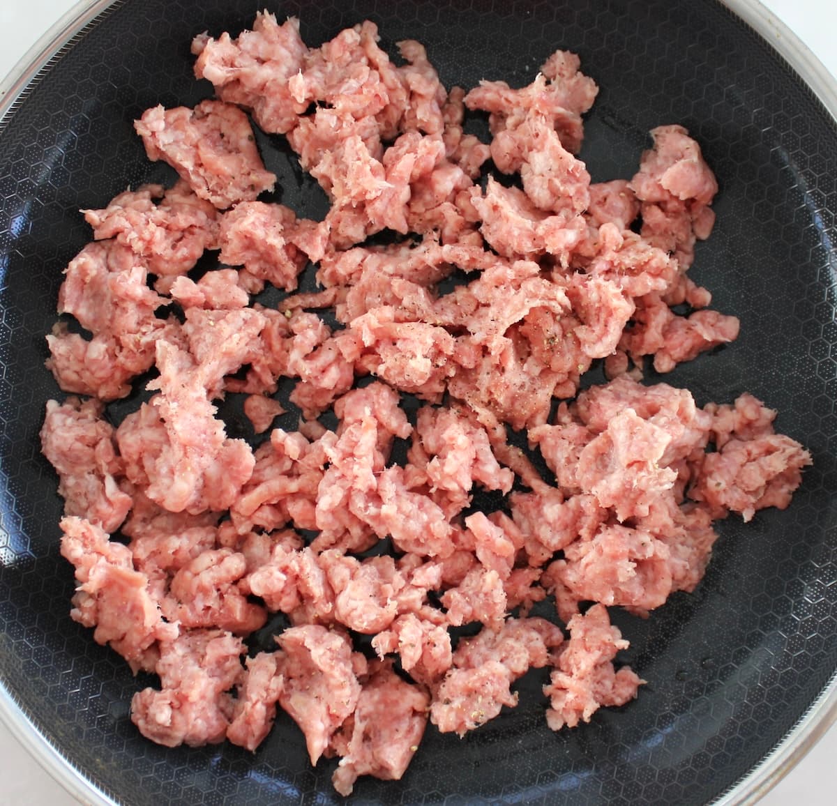 ground pork cooking in skillet