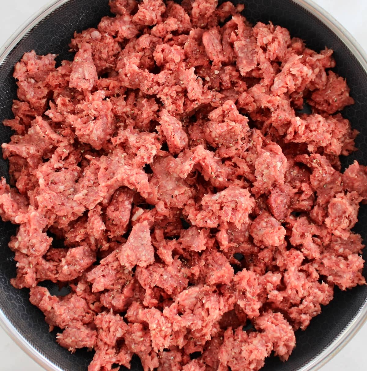 raw ground beef in skillet