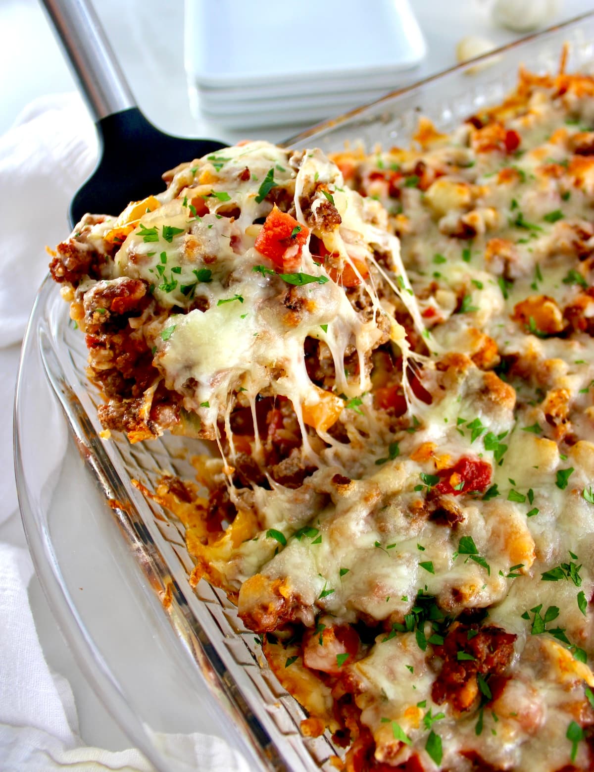 spatula lifting piece of Stuffed Pepper Casserole with cheese pulling