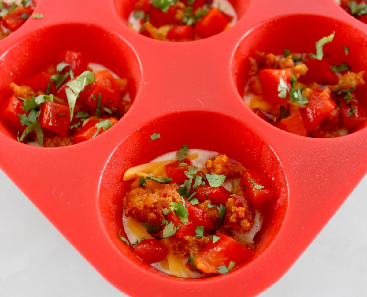 chorizo, cheddar , cilantro and roasted peppers in red muffin cup
