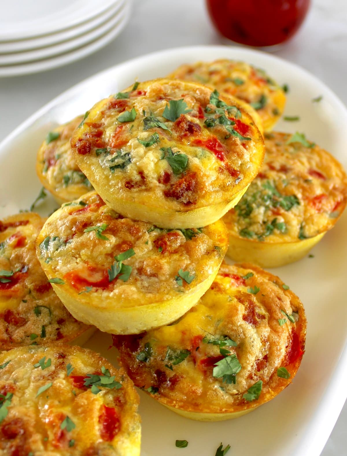 Chorizo and Pepper Egg Muffins stacked up on white plate