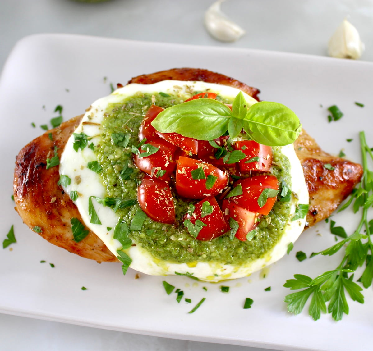 overhead view of Grilled Chicken Margherita on white plate