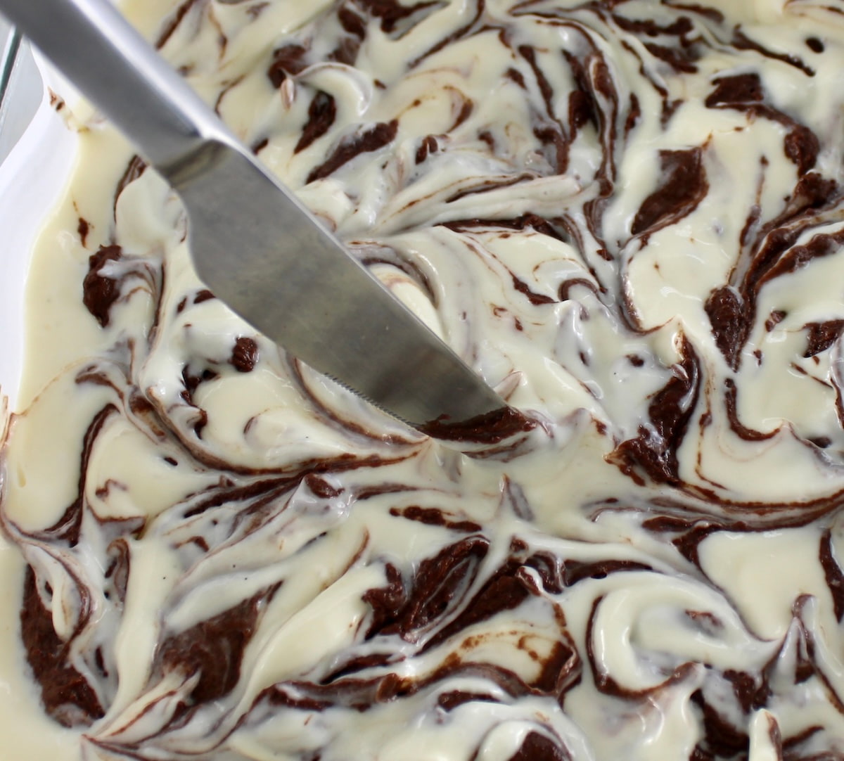 Keto Cheesecake Brownie Bars batter with knife running through the batter