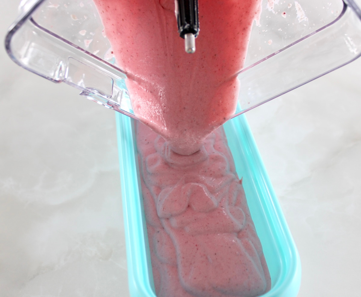 Strawberry Cottage Cheese Ice Cream pouring into blue storage container