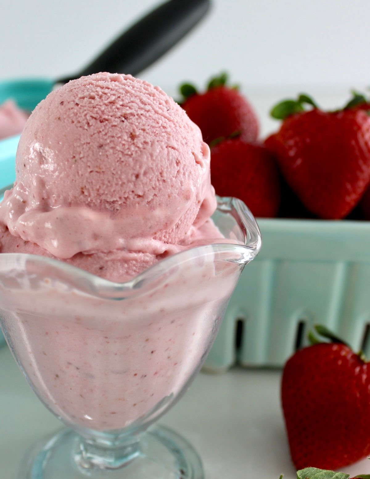 closeup of Strawberry Cottage Cheese Ice Cream in glass with strawberries in back