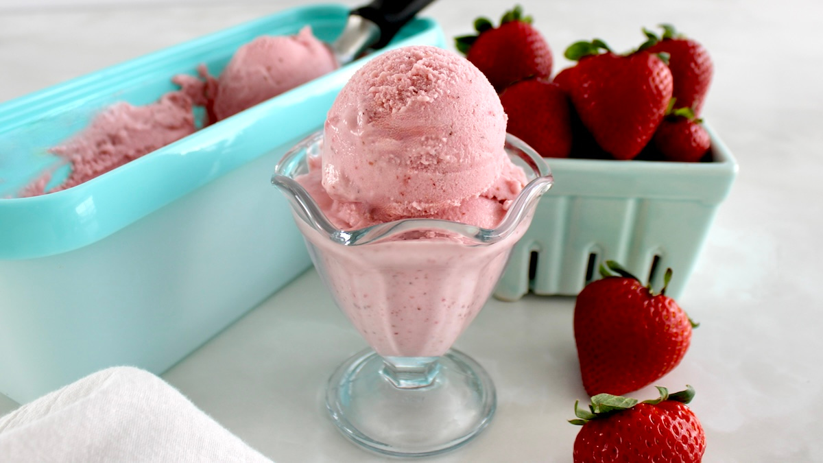Strawberry Cottage Cheese Ice Cream in glass with strawberries and more ice cream in back