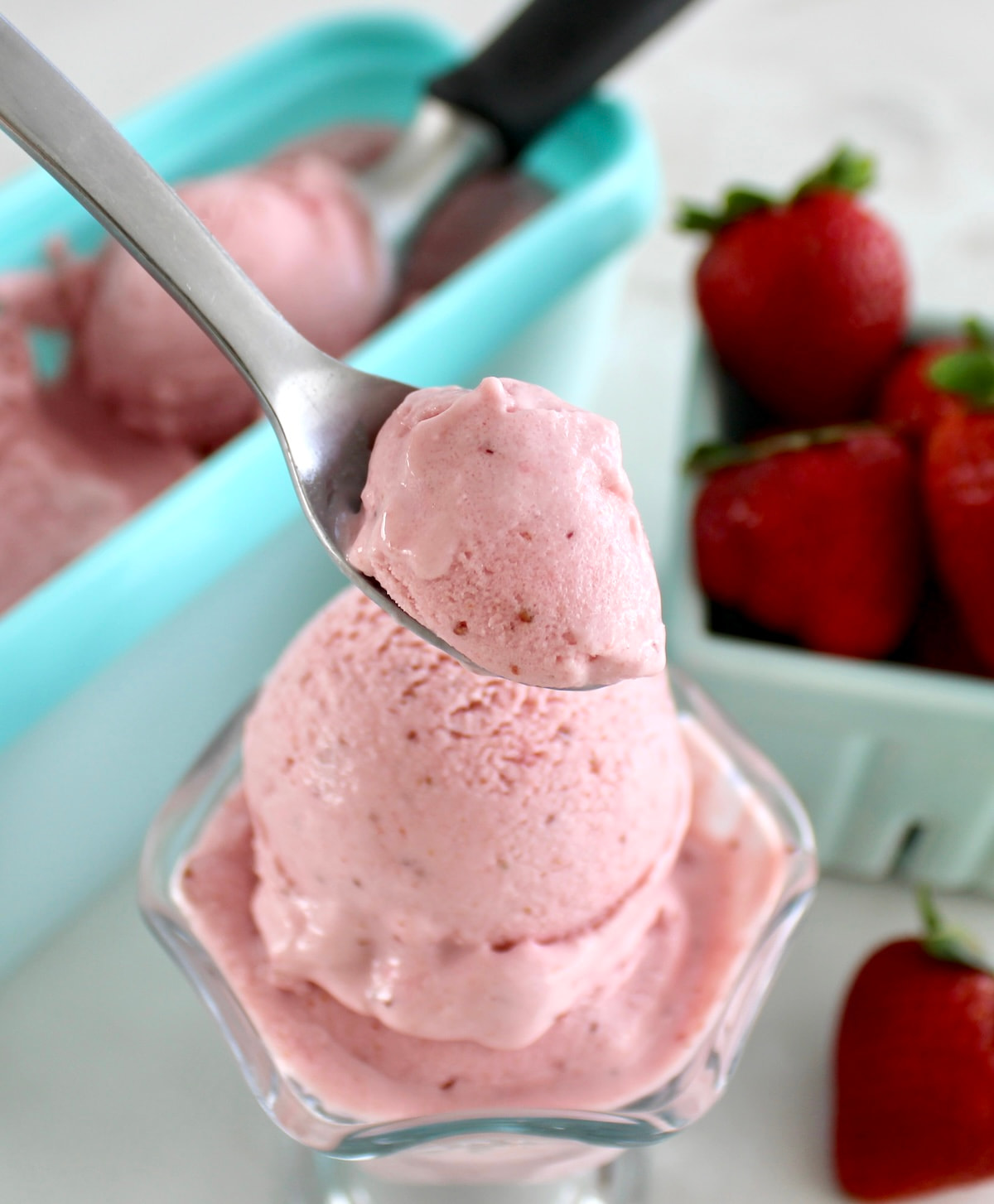 closeup of Strawberry Cottage Cheese Ice Cream with spoonful held up over glass
