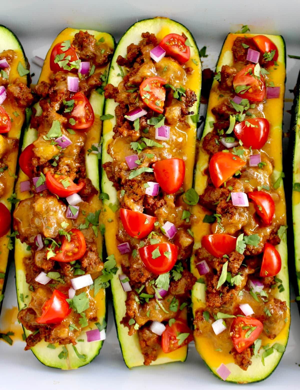 closeup overhead of  Taco Zucchini Boats in white casserole