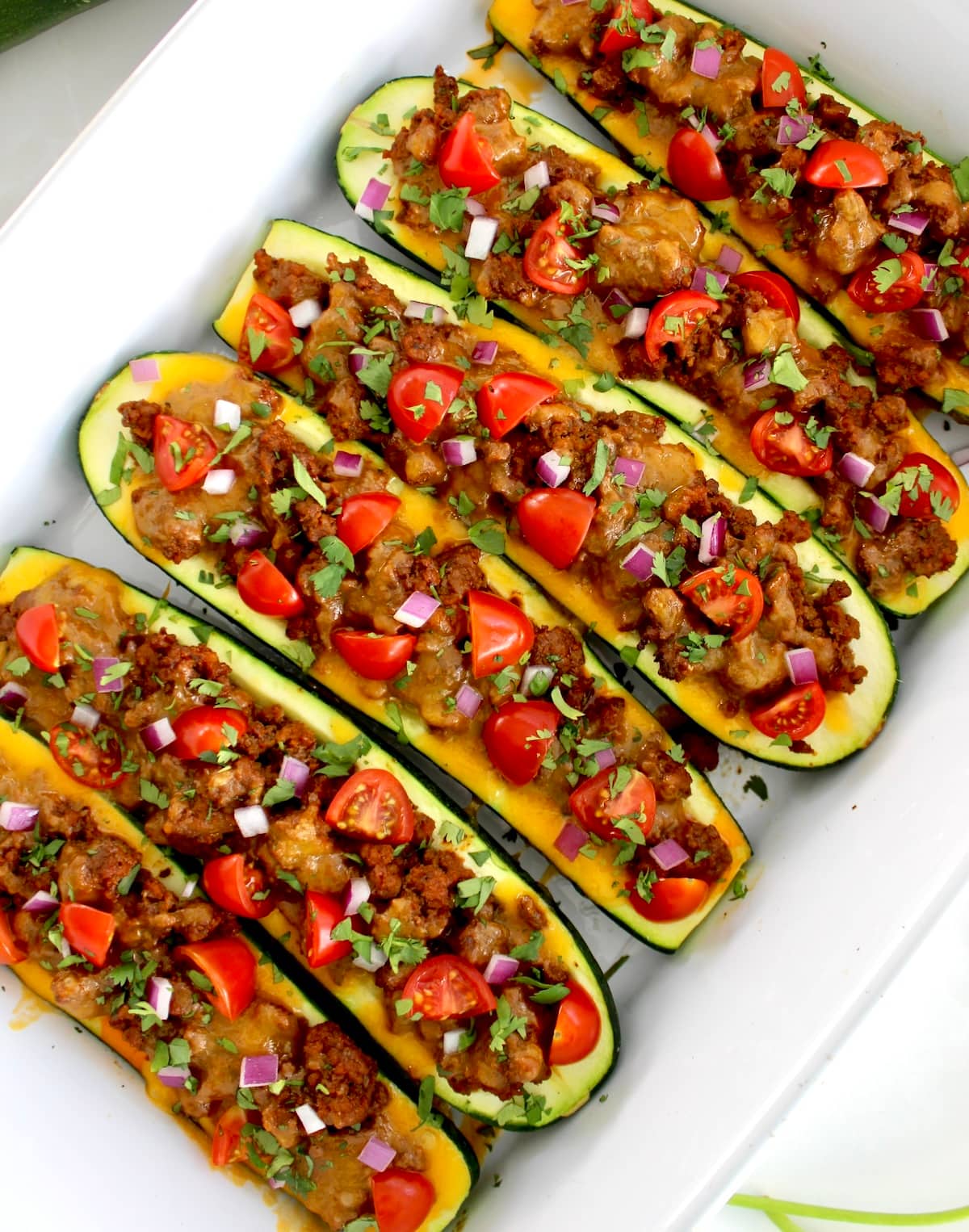 overhead closeup of  Taco Zucchini Boats in white casserole