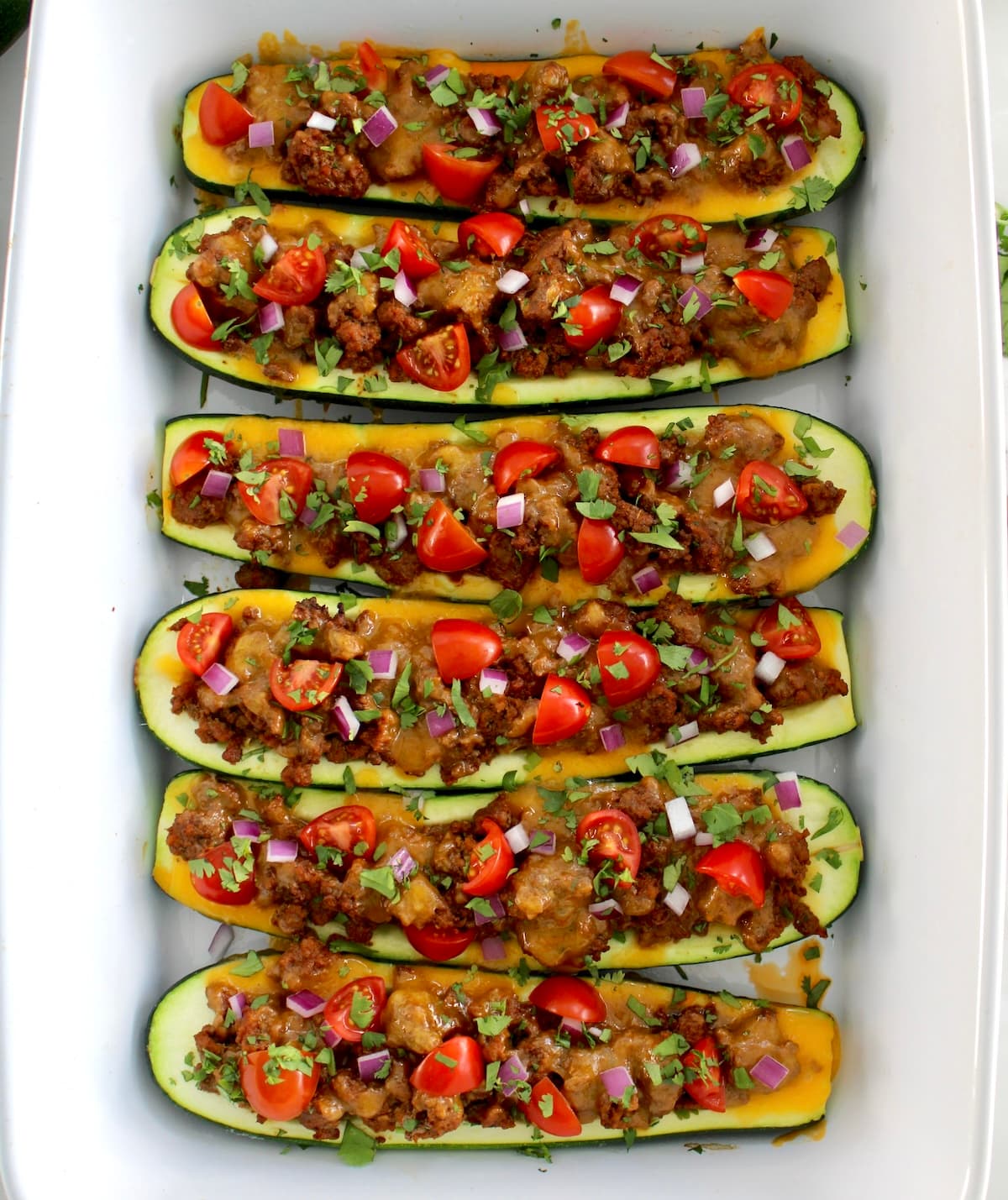 overhead view of 6 Taco Zucchini Boats in white casserole
