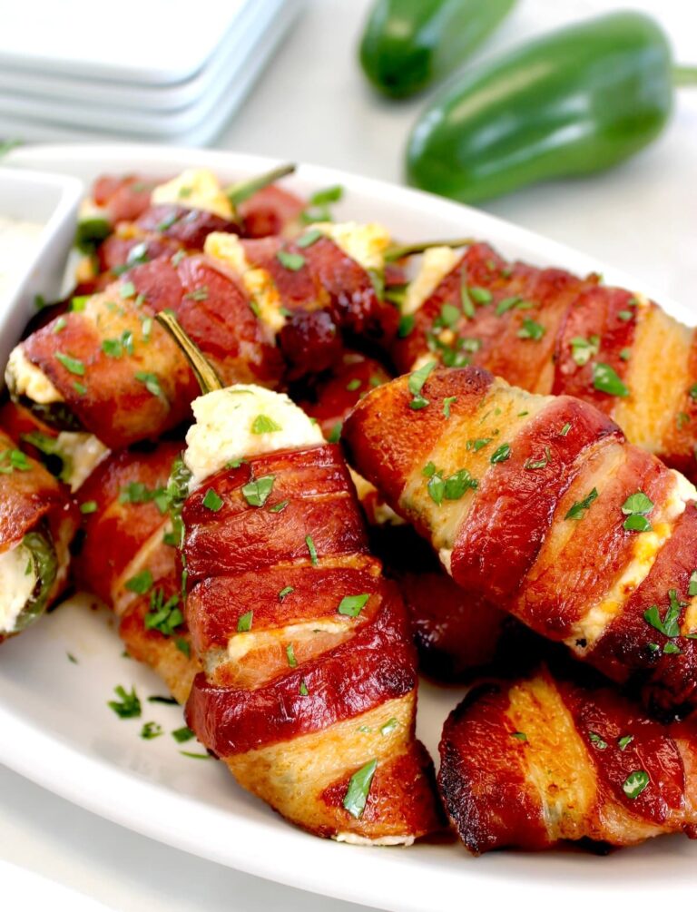 Air Fryer Bacon Wrapped Jalapeño Poppers on white plate with chopped parsley