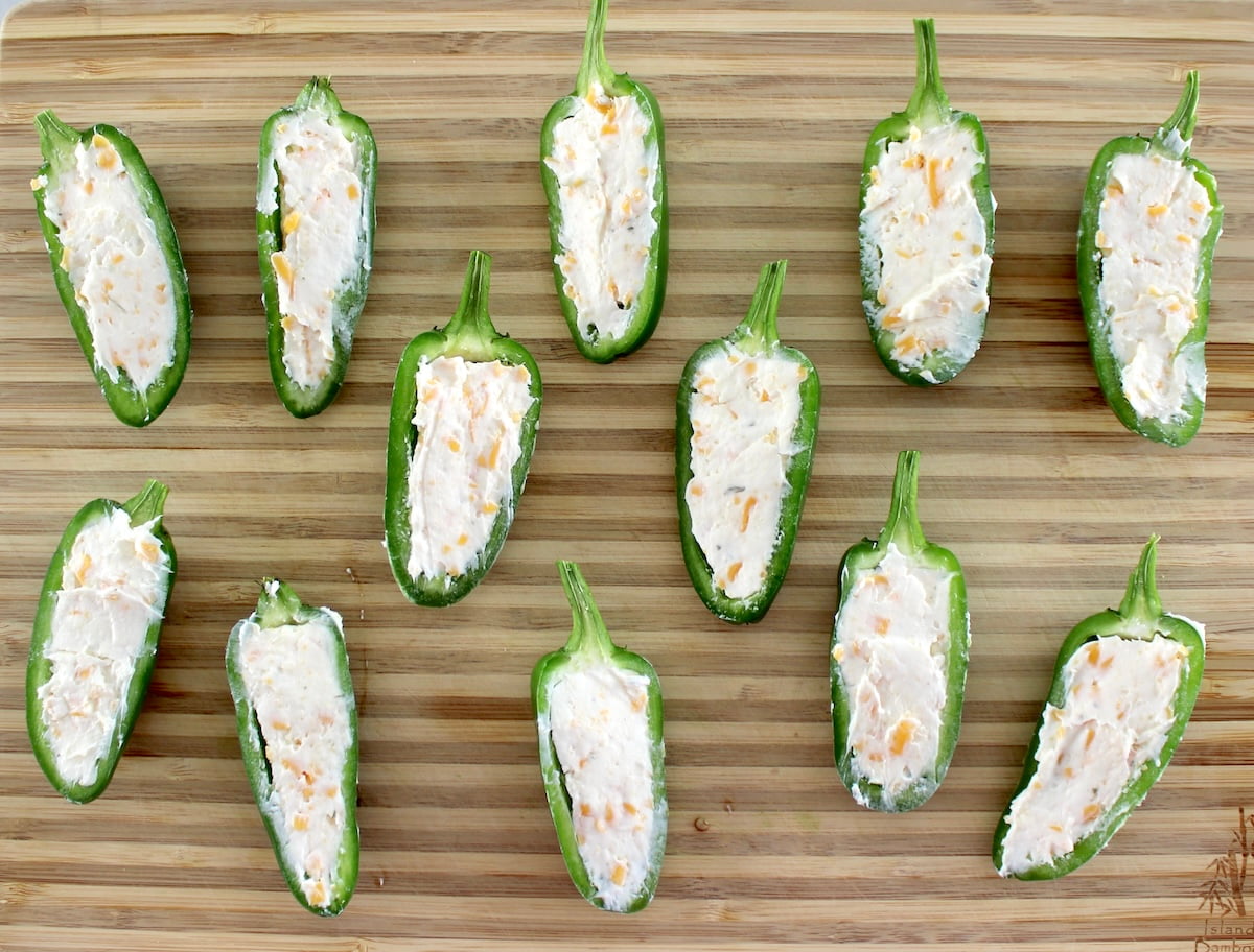 12 cheese filled jalapeño poppers on cutting board