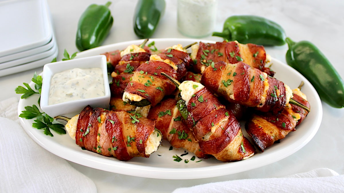 Air Fryer Bacon Wrapped Jalapeño Poppers on white oval plate with ranch on side