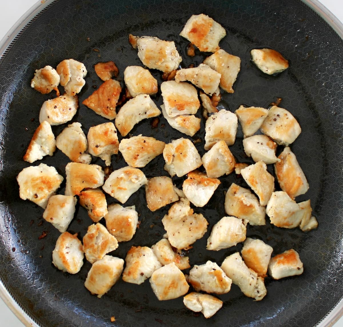 saut&eacute;ed chicken bites in skillet