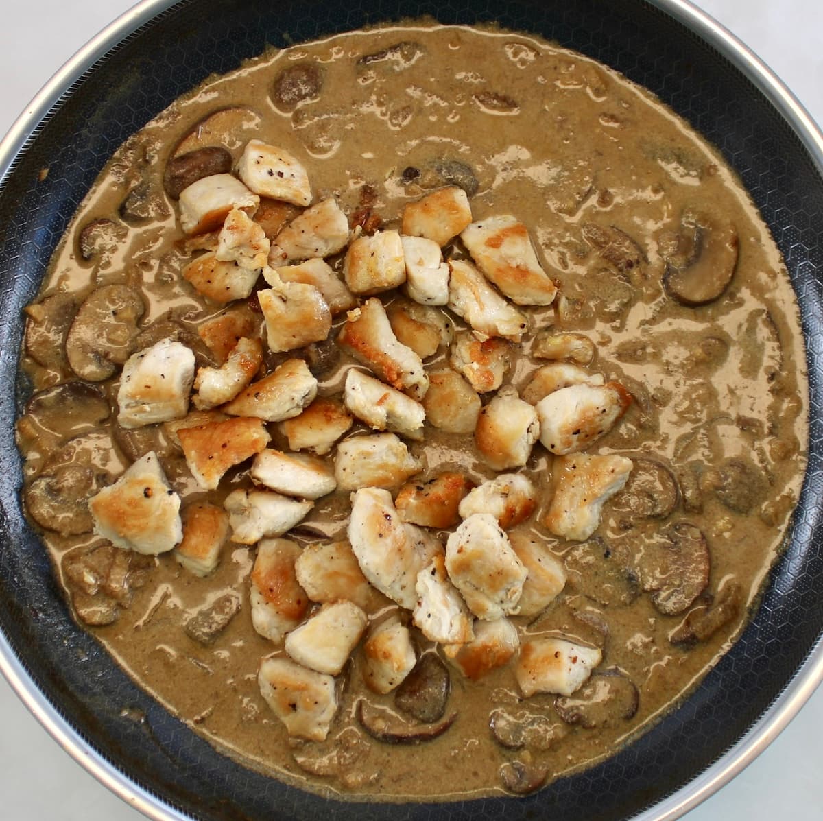 Chicken Stroganoff cooking in skillet