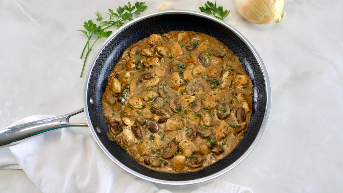 overhead view of Chicken Stroganoff in skillet with chopped parsley